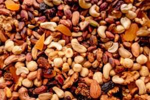 Close-up of assorted nuts and dried fruits creating a colorful, nutritious mix.