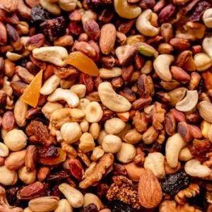 Close-up of assorted nuts and dried fruits creating a colorful, nutritious mix.